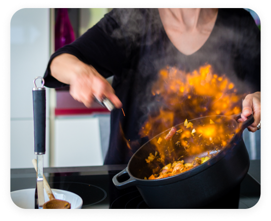 Chef tossing vegetables in a HexClad pan